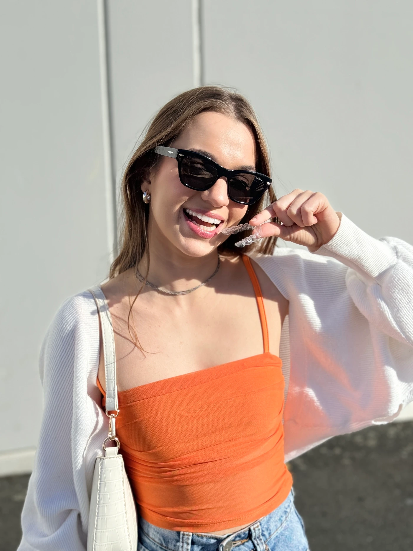ClearChange creator showing her removable aligner outdoors