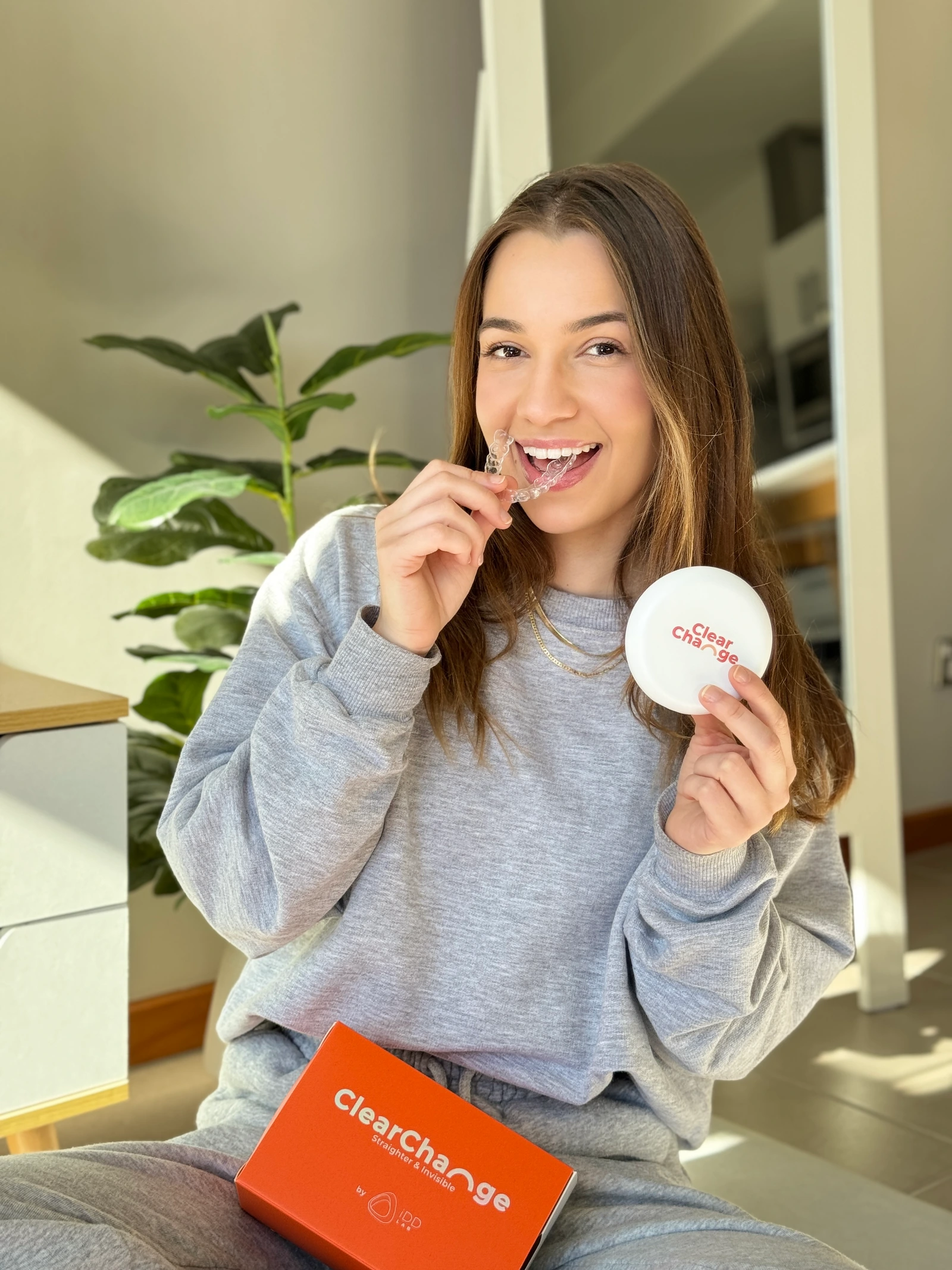 ClearChange creator holding her aligner and branded case